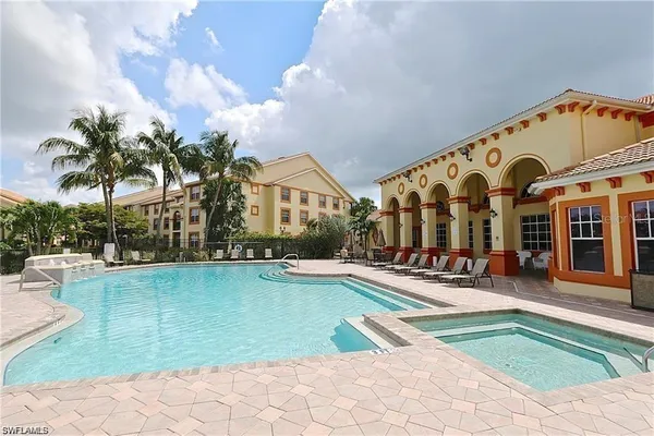 a view of swimming pool with outdoor seating and a potted plant