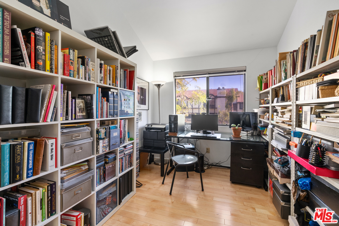19355 Sherman Way, Unit 33 Reseda, CA 91335 - Photo 11 of 22 a room with furniture lots of books and a large window