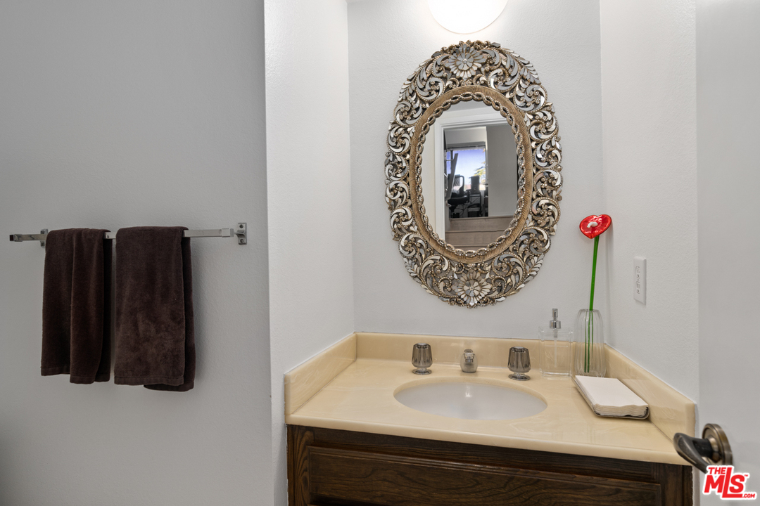 19355 Sherman Way, Unit 33 Reseda, CA 91335 - Photo 13 of 22 a bathroom with a sink and a mirror