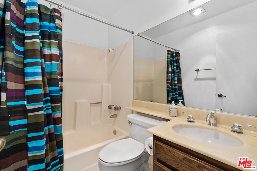 19355 Sherman Way, Unit 33 Reseda, CA 91335 - Photo 14 of 22 a bathroom with a sink toilet and shower