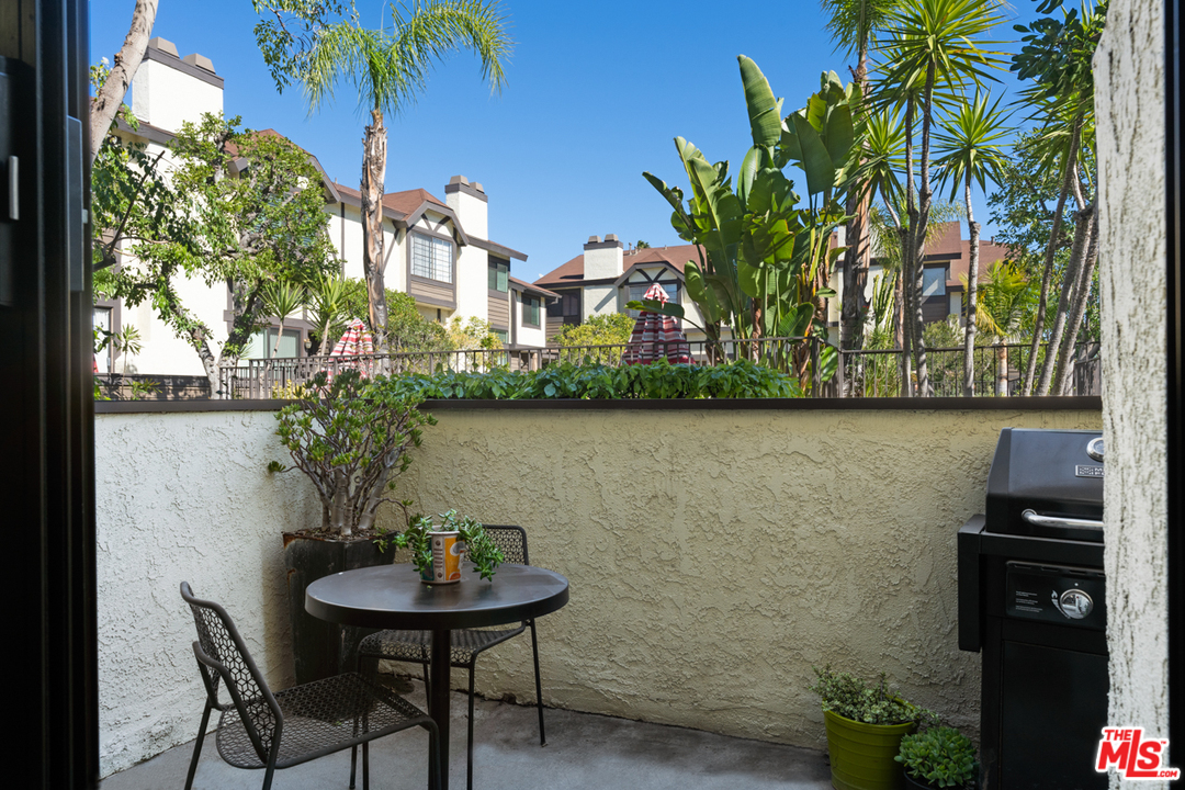 19355 Sherman Way, Unit 33 Reseda, CA 91335 - Photo 15 of 22 a view of a balcony with chairs and a potted plant