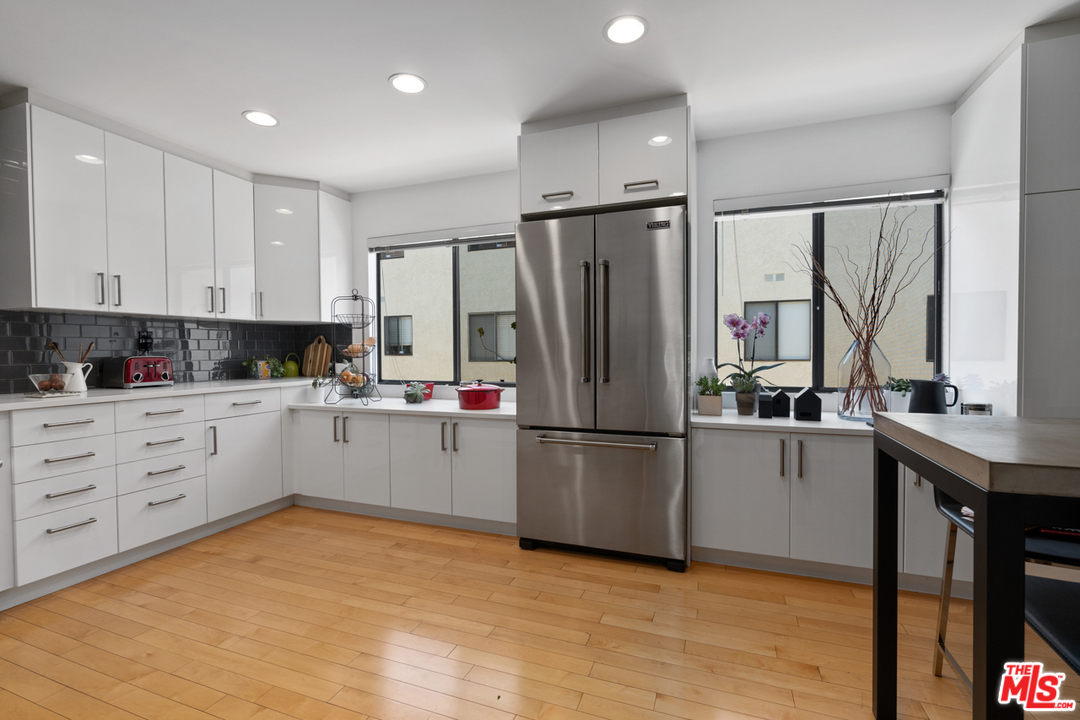 19355 Sherman Way, Unit 33 Reseda, CA 91335 - Photo 4 of 22 a kitchen with white cabinets and white appliances