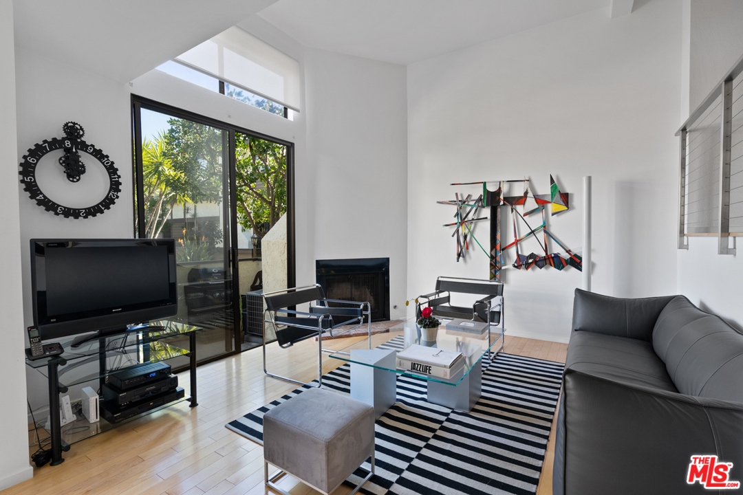 19355 Sherman Way, Unit 33 Reseda, CA 91335 - Photo 8 of 22 a living room with furniture and a flat screen tv