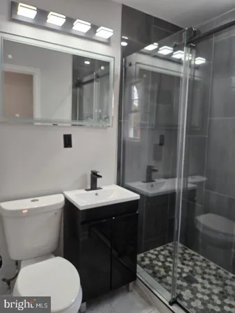 a bathroom with a sink toilet and shower