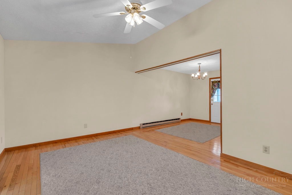 163 Rolling Hill Drive Boone, NC 28607 - Photo 9 of 40 a view of an empty room with a chandelier fan
