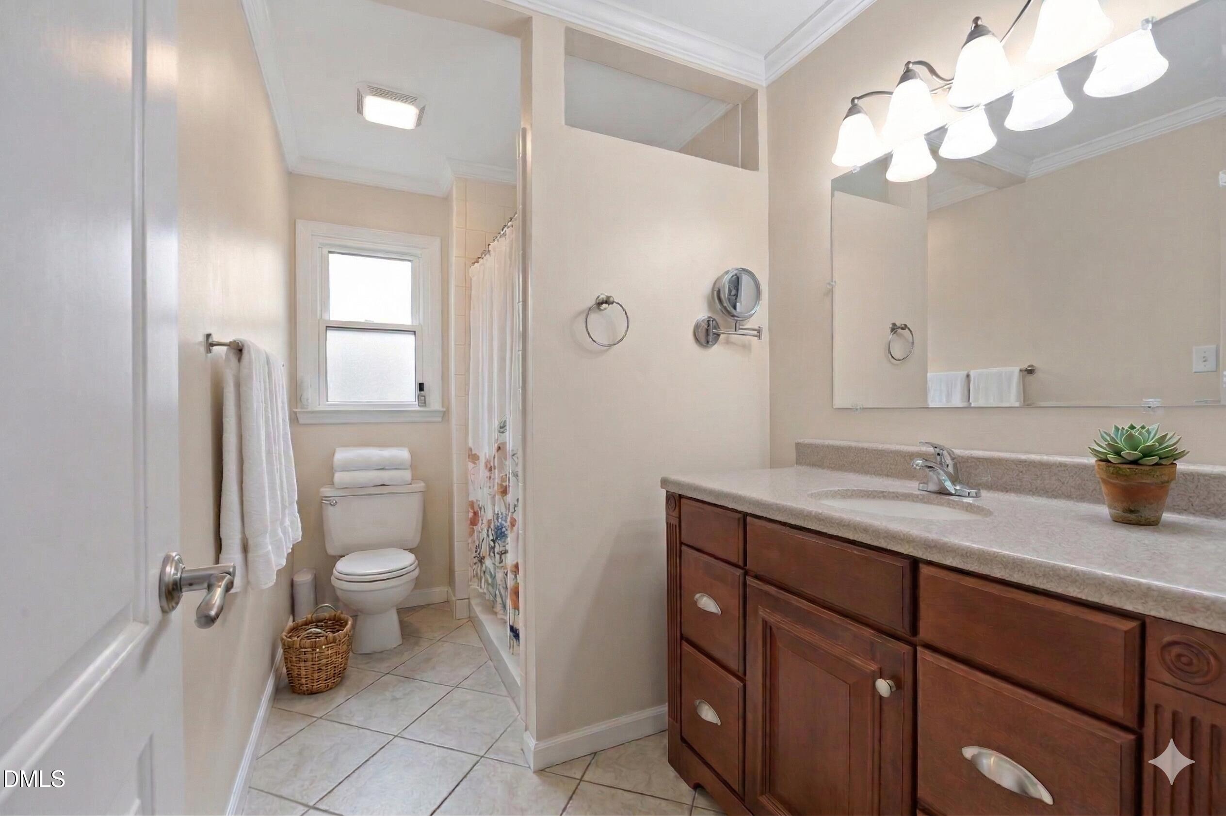 212 Esquire Lane Cary, NC 27513 - Photo 12 of 31 a bathroom with a granite countertop sink a toilet and a mirror