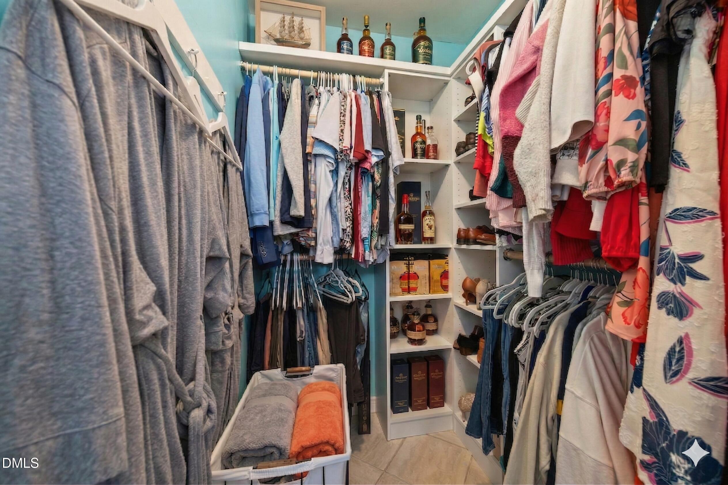 212 Esquire Lane Cary, NC 27513 - Photo 13 of 31 a view of walk in closet with clothes