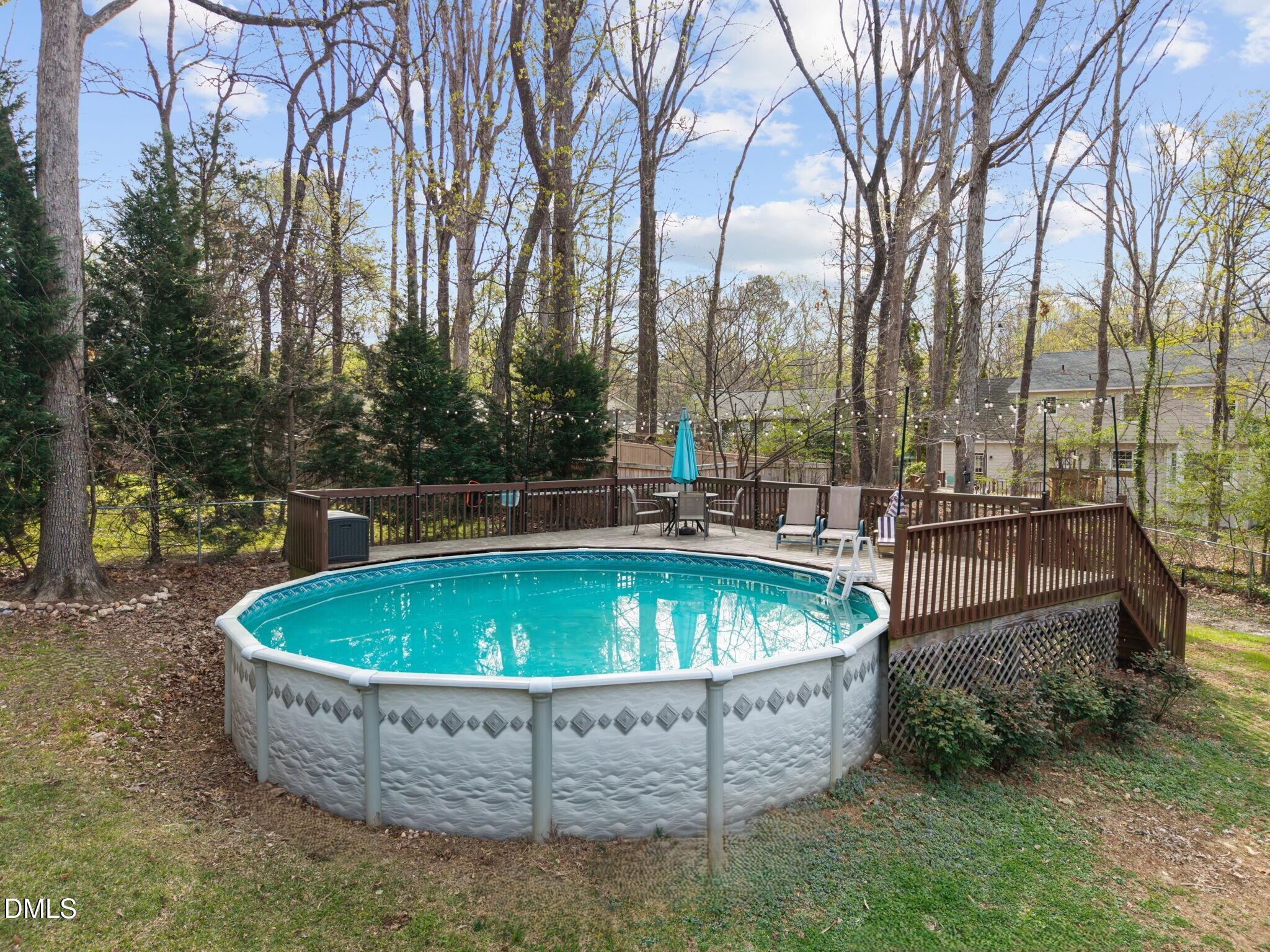 212 Esquire Lane Cary, NC 27513 - Photo 22 of 31 a view of a swimming pool with a fountain and trees