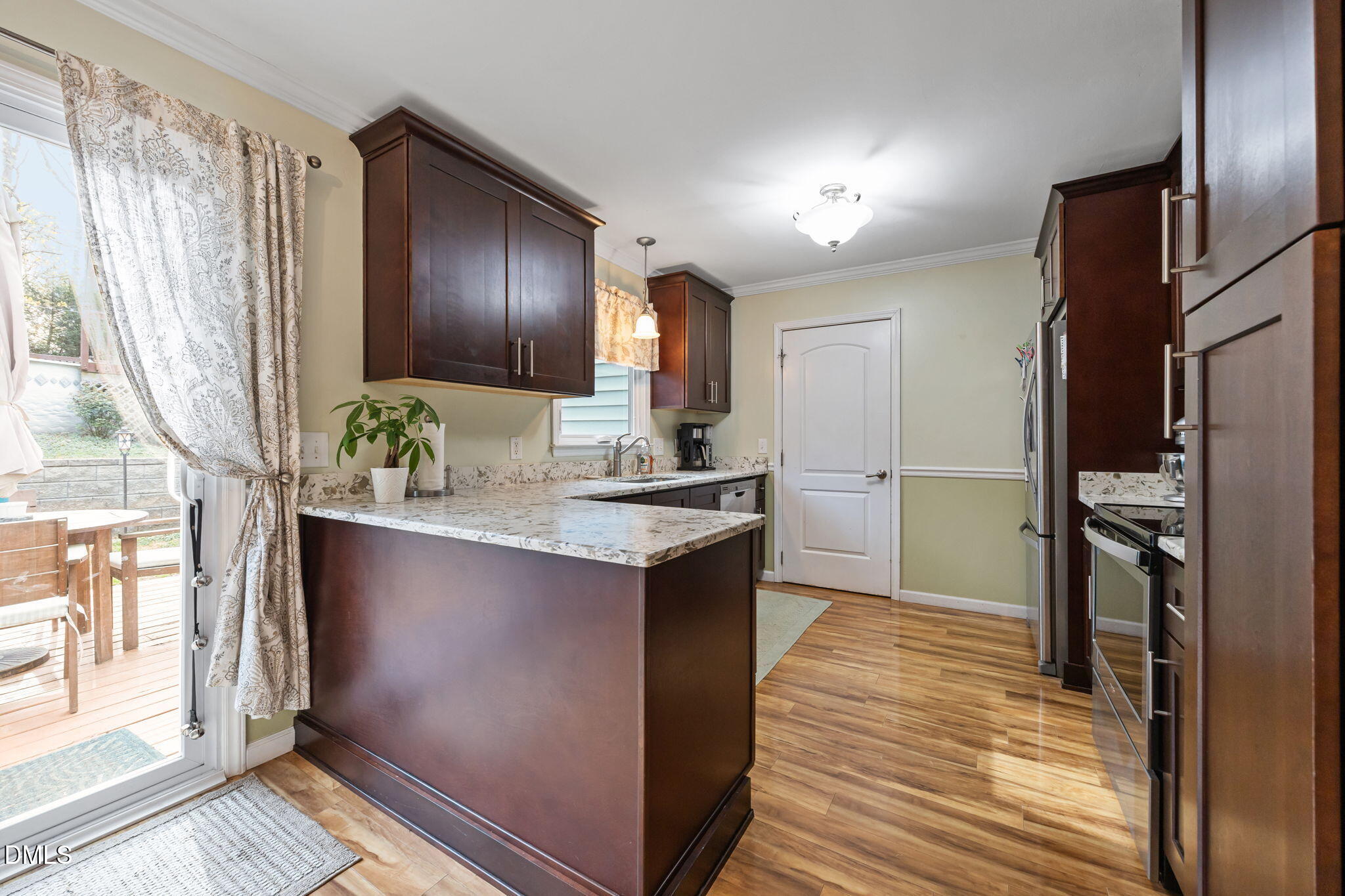 212 Esquire Lane Cary, NC 27513 - Photo 5 of 31 a kitchen with stainless steel appliances granite countertop a refrigerator a stove and a sink with wooden floor