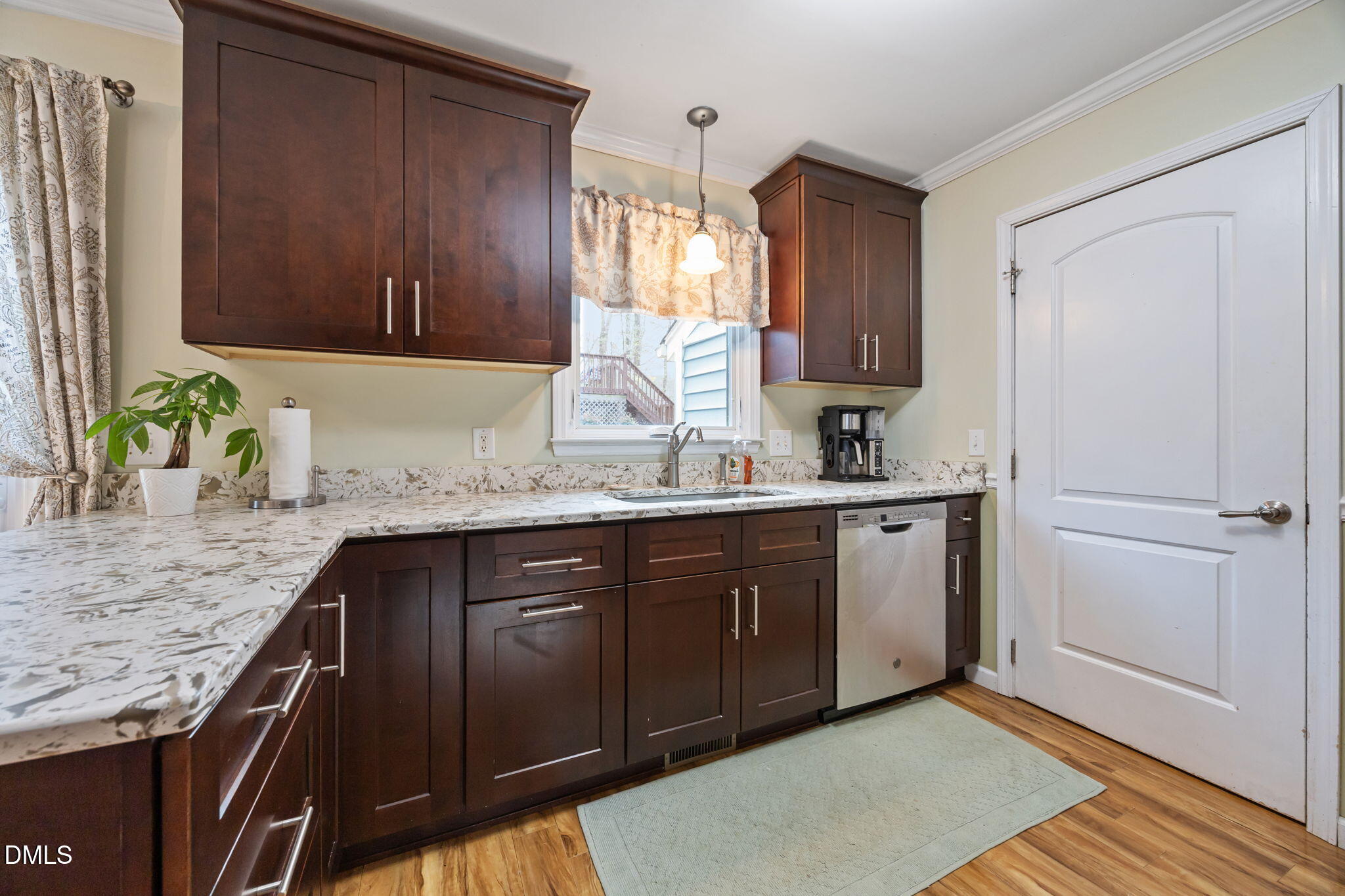 212 Esquire Lane Cary, NC 27513 - Photo 6 of 31 a kitchen with granite countertop wooden cabinets and a sink
