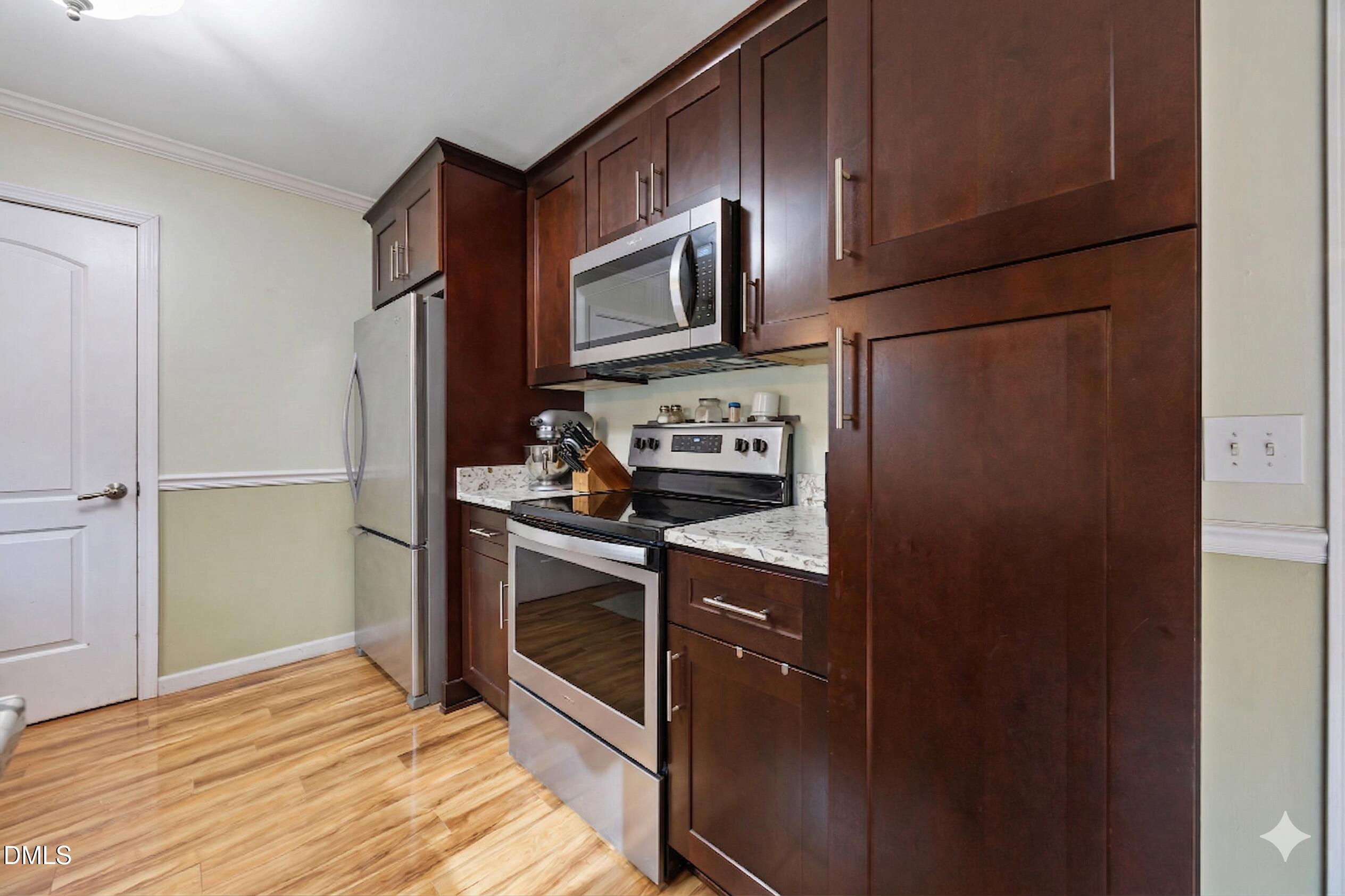 212 Esquire Lane Cary, NC 27513 - Photo 7 of 31 a kitchen with stainless steel appliances granite countertop a refrigerator stove and sink