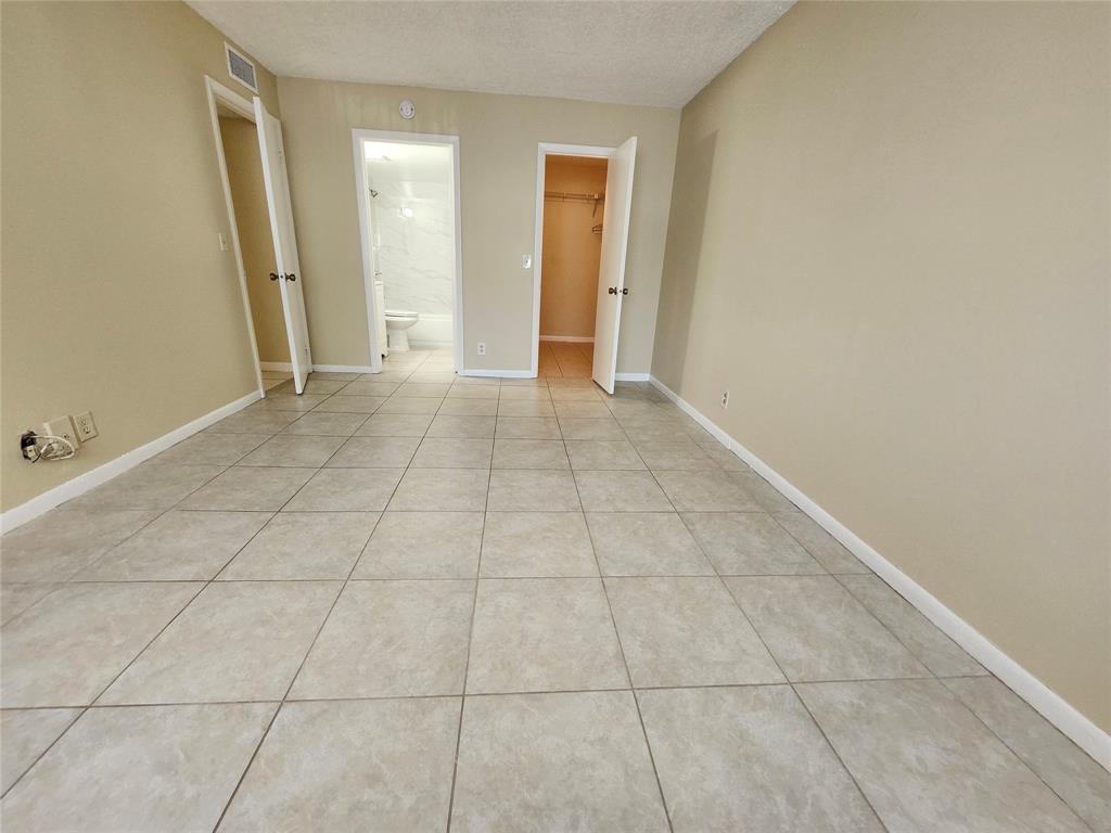545 Trace Circle, Unit 105 Deerfield Beach, FL 33441 - Photo 15 of 44 a view of an empty room and fire place