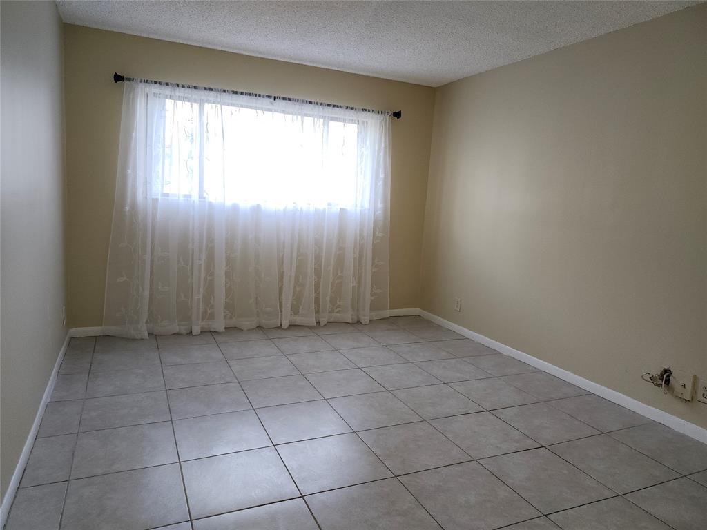 545 Trace Circle, Unit 105 Deerfield Beach, FL 33441 - Photo 18 of 44 an empty room with windows