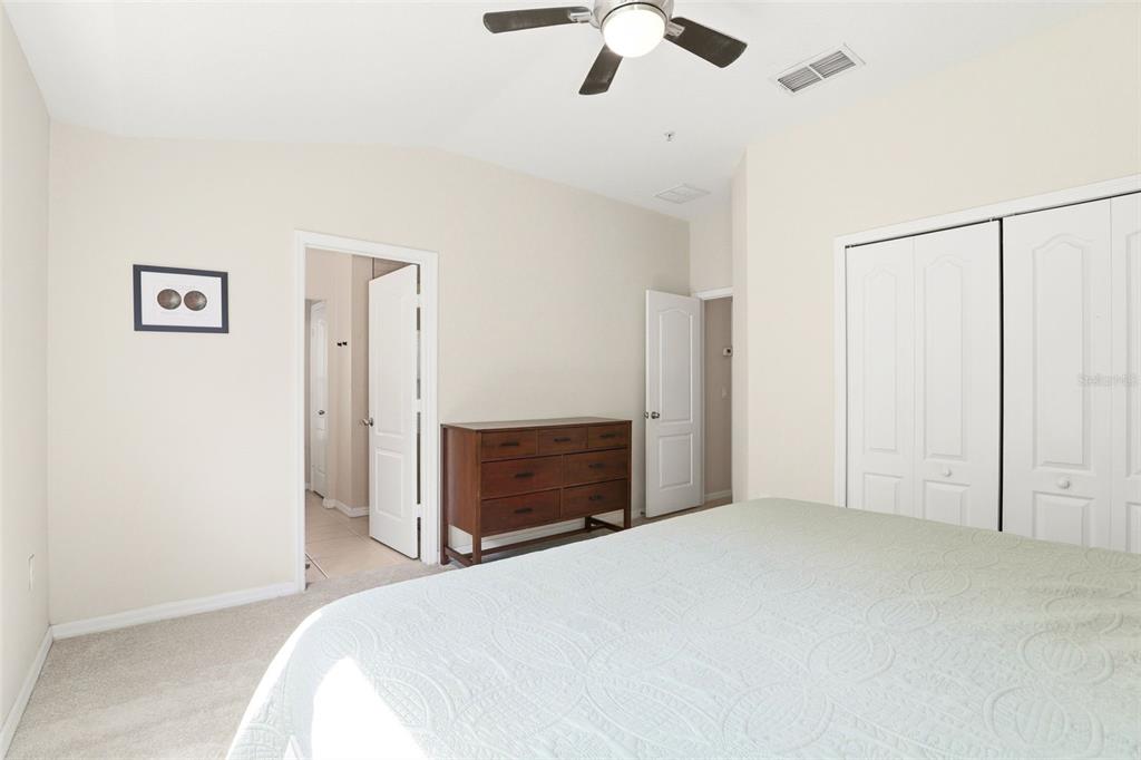 6458 South Goldenrod Road, Unit 29B Orlando, FL 32822 - Photo 20 of 40 a bedroom with a bed and a chandelier