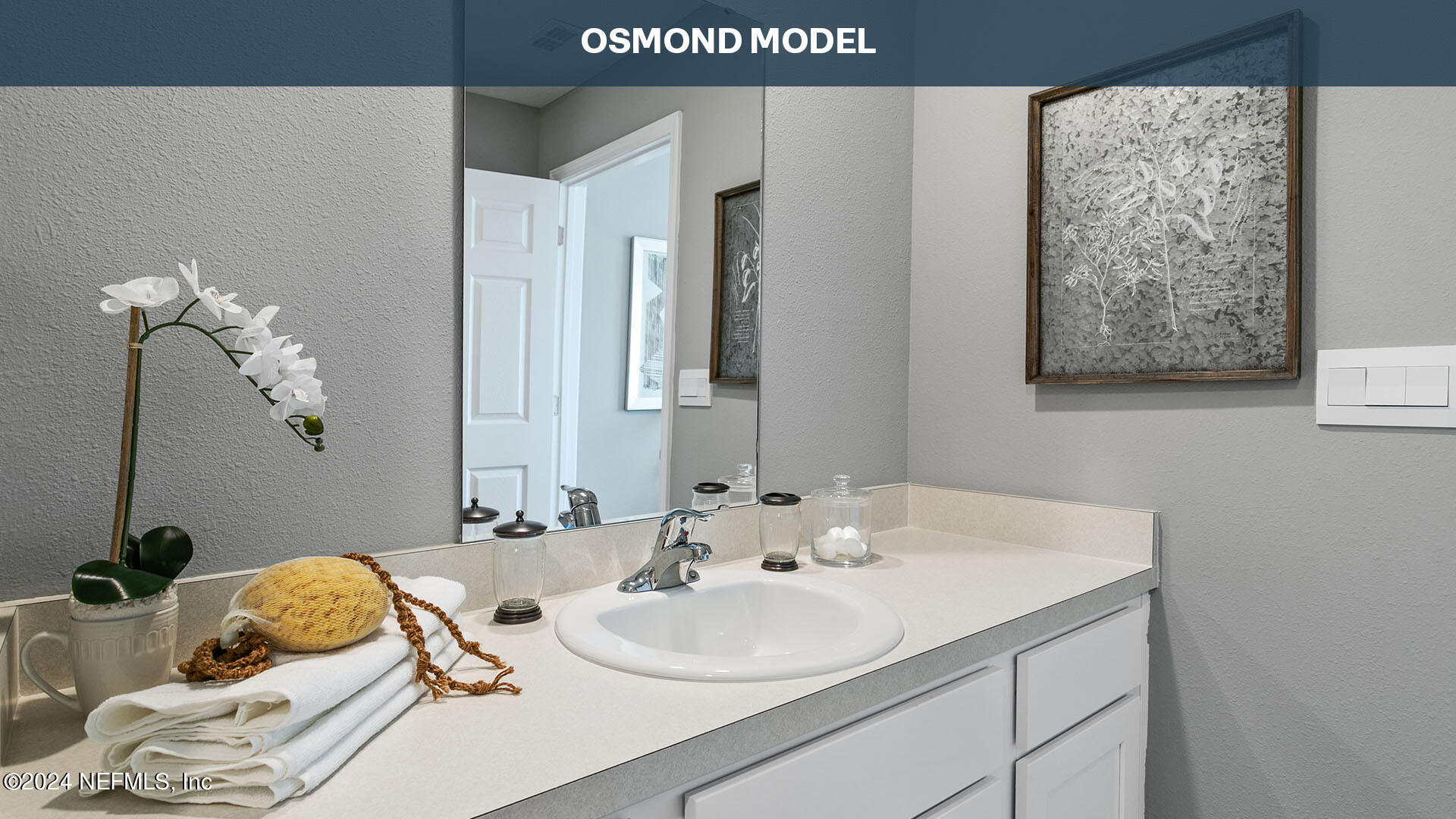 196 Stonegate Avenue St. Augustine, FL 32084 - Photo 16 of 32 a bathroom with a sink and a mirror