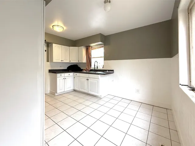 a kitchen with granite countertop a sink and a stove