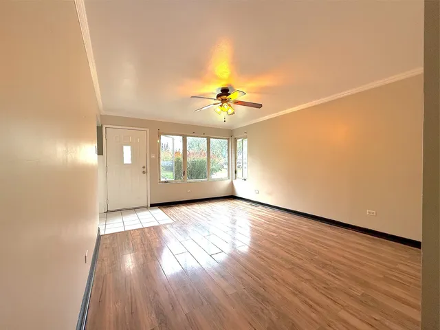 an empty room with wooden floor and a window