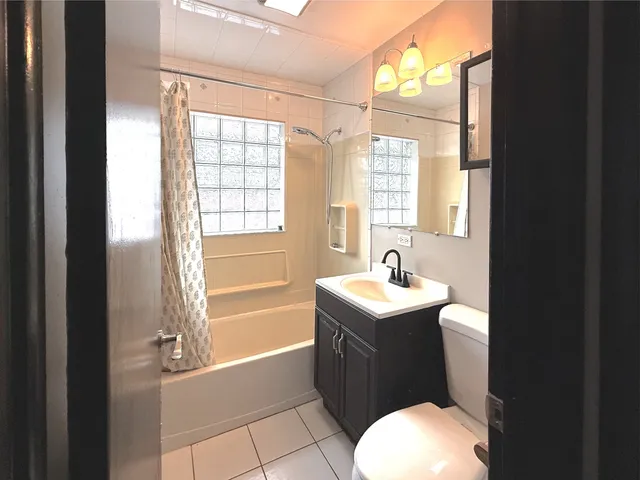 a bathroom with a sink toilet and tub