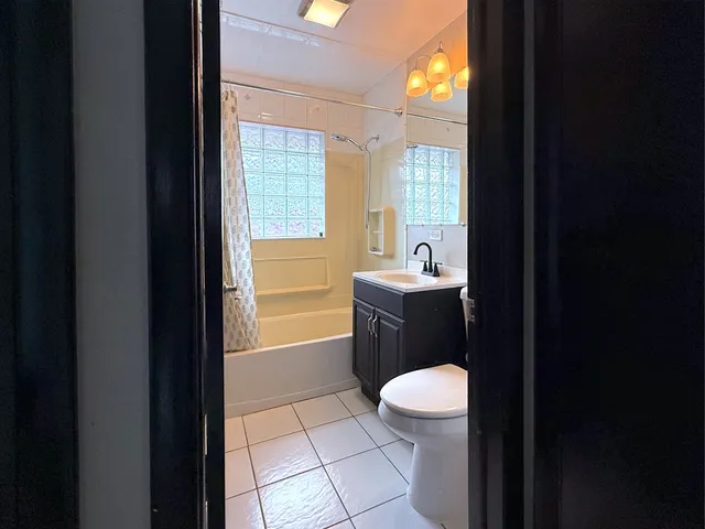 a bathroom with a sink a toilet and a shower