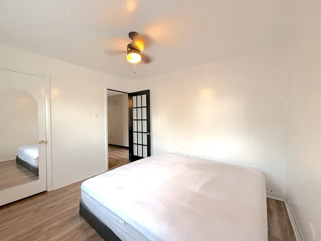 a bedroom with a bed and a painting on the wall