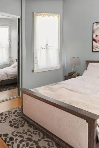 a bedroom with a bed and a window