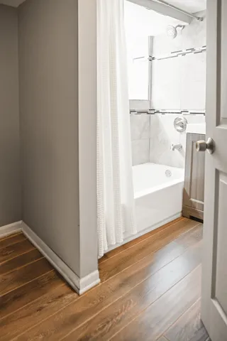 a bathroom with a tub and shower