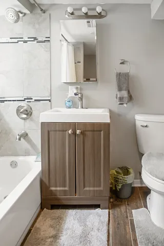 a bathroom with a sink toilet and shower
