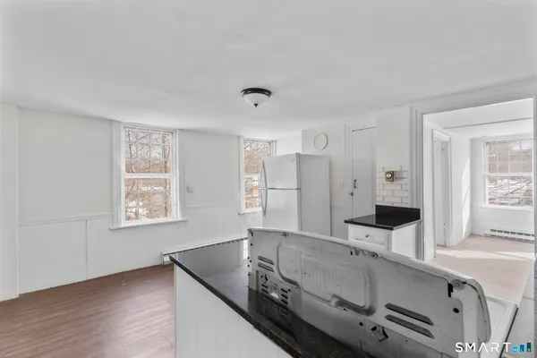 a bathroom with a granite countertop sink and a large mirror