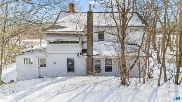 a view of a house with a snow in the background