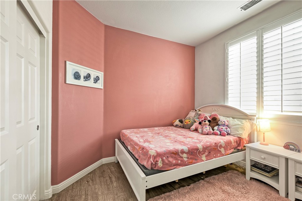 3894 Polk Street, Unit E Riverside, CA 92505 - Photo 11 of 28 a bedroom with a bed and a window