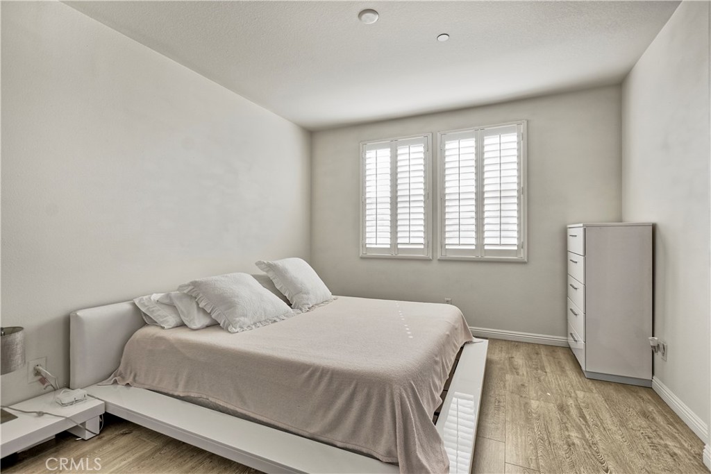 3894 Polk Street, Unit E Riverside, CA 92505 - Photo 14 of 28 a bedroom with a bed and a window