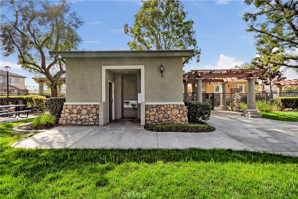 3894 Polk Street, Unit E Riverside, CA 92505 - Photo 25 of 28 a view of a house with a garden and pathway