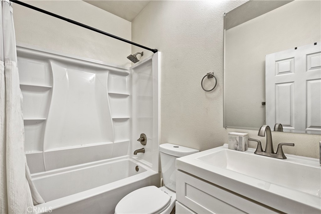 3894 Polk Street, Unit E Riverside, CA 92505 - Photo 10 of 28 a bathroom with a sink toilet vanity and shower
