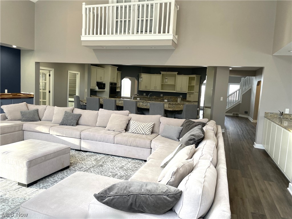 9427 Hubbard Valley Road Seville, OH 44273 - Photo 10 of 34 Living room featuring hardwood / wood-style floors and a towering ceiling