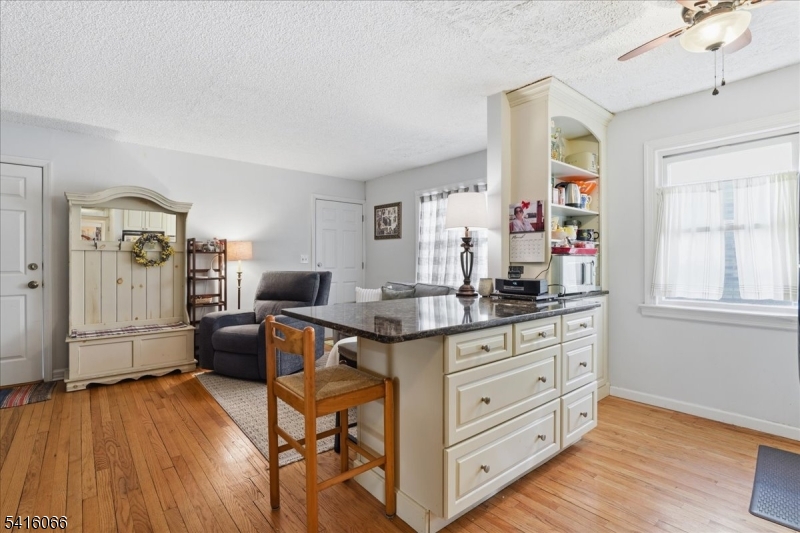 753 Broad Avenue, Unit A Ridgefield, NJ 07657 - Photo 11 of 23 a kitchen with granite countertop a sink cabinets and wooden floor