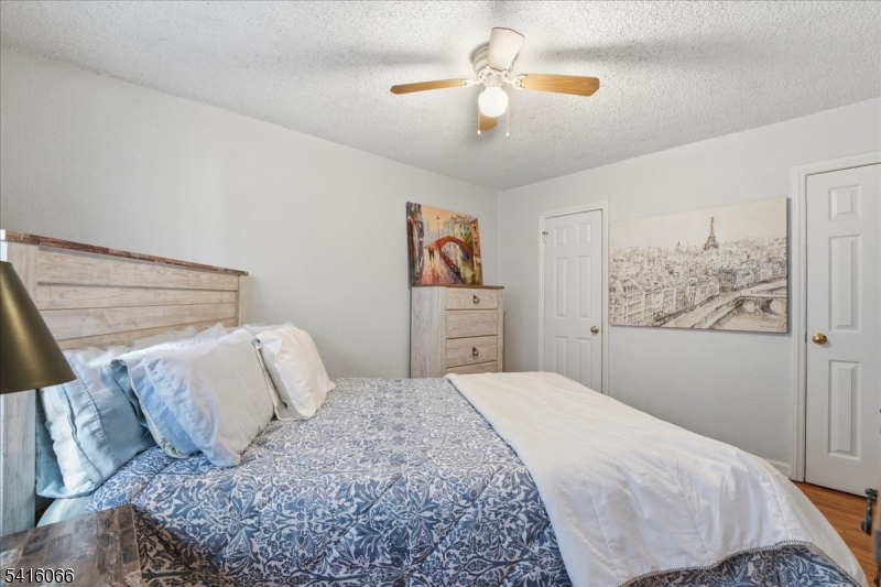 753 Broad Avenue, Unit A Ridgefield, NJ 07657 - Photo 15 of 23 a bedroom with a large bed and a chandelier