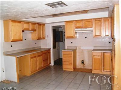 11561 Shawnee Road Fort Myers, FL 33913 - Photo 3 of 10 a kitchen with stainless steel appliances granite countertop a refrigerator and a stove