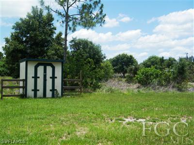 11561 Shawnee Road Fort Myers, FL 33913 - Photo 9 of 10 a big yard with swimming pool and large trees