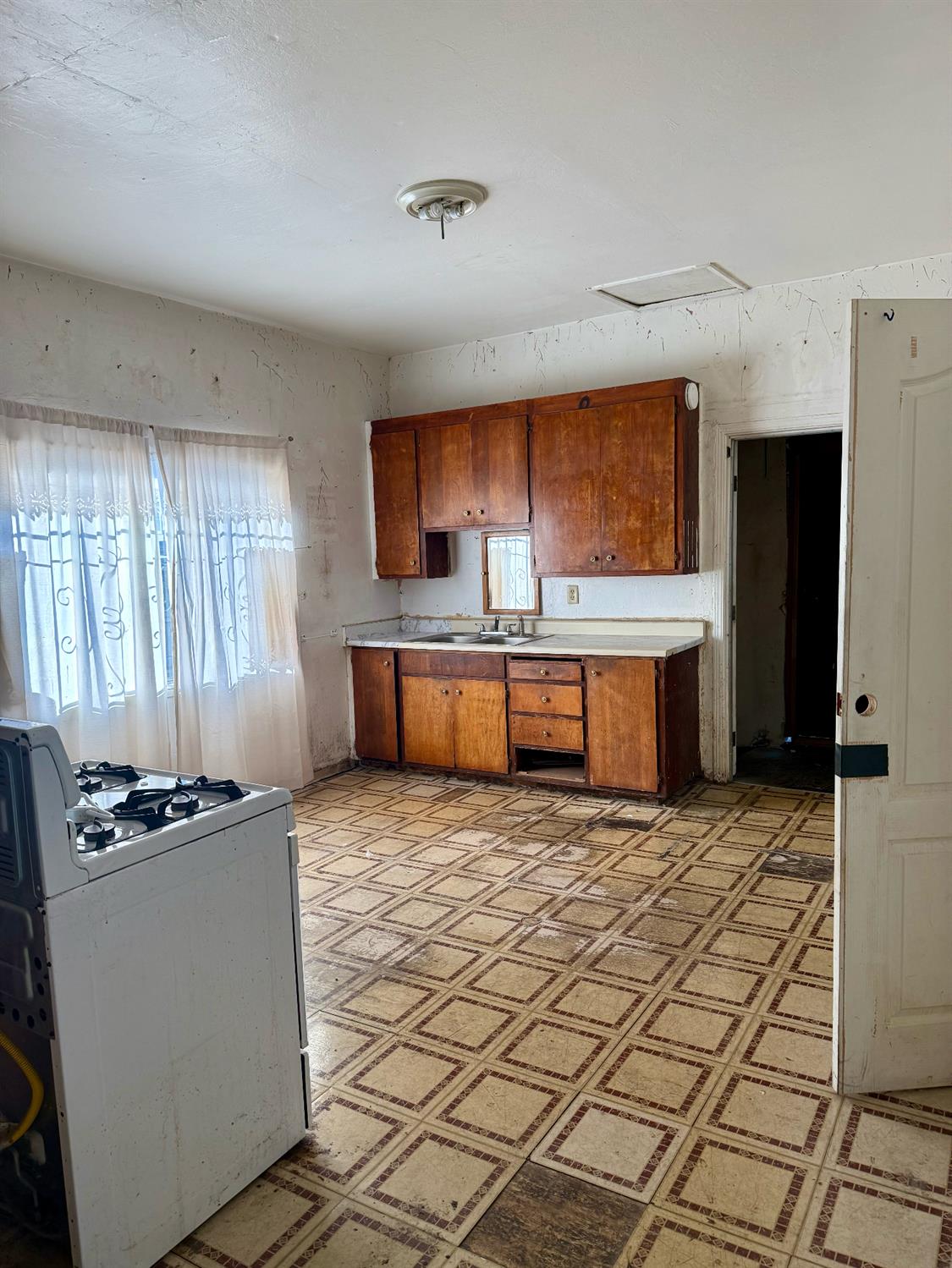 641 9th Street Richmond, CA 94801 - Photo 5 of 14 a kitchen with granite countertop a stove a sink and a refrigerator