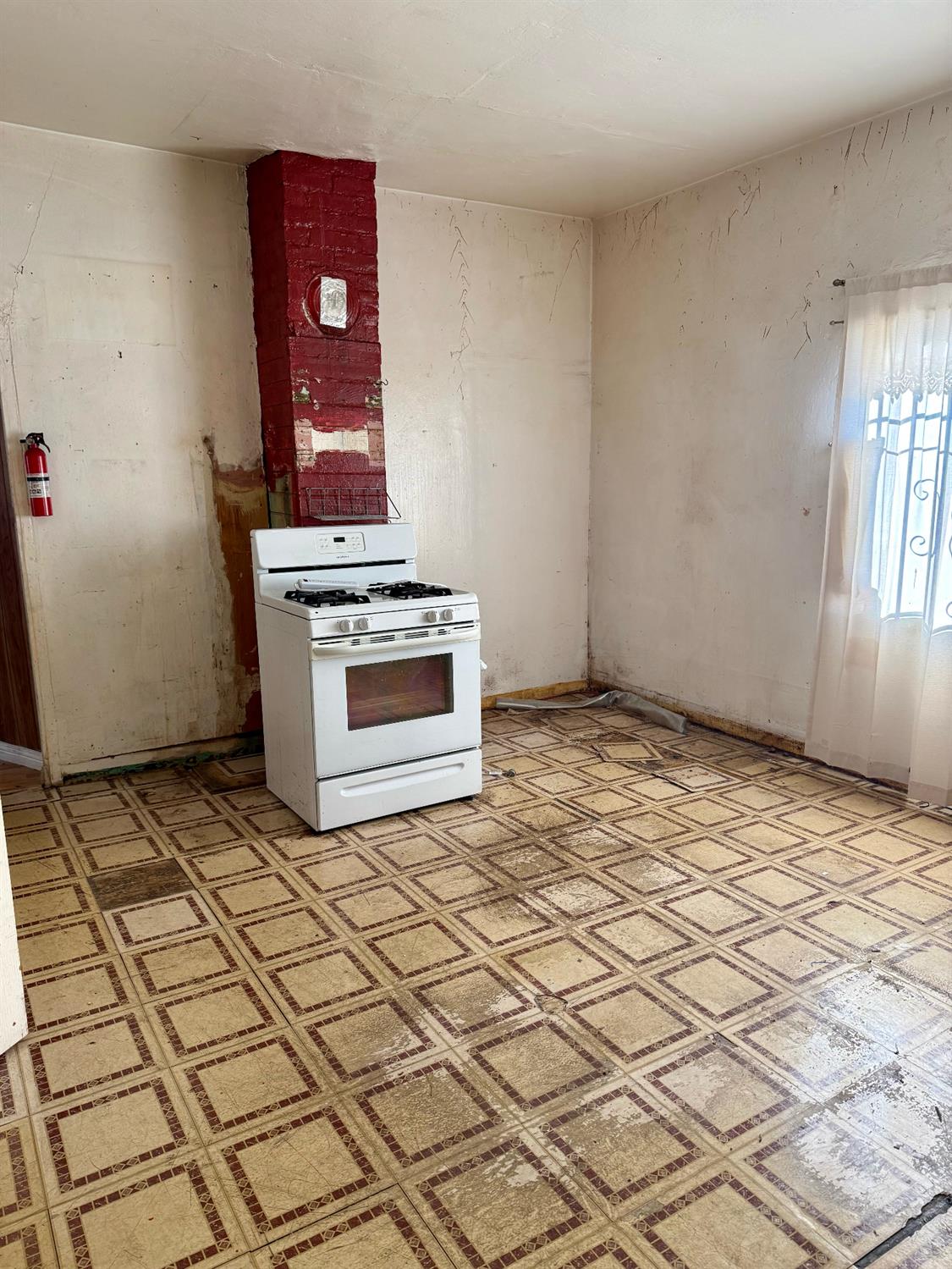 641 9th Street Richmond, CA 94801 - Photo 6 of 14 a view of a livingroom with wooden floor and a refrigerator