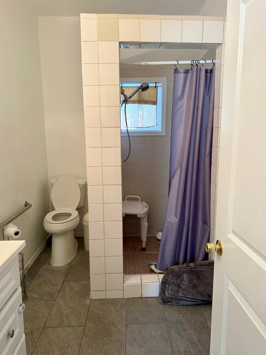 641 9th Street Richmond, CA 94801 - Photo 7 of 14 a bathroom with a toilet and a mirror