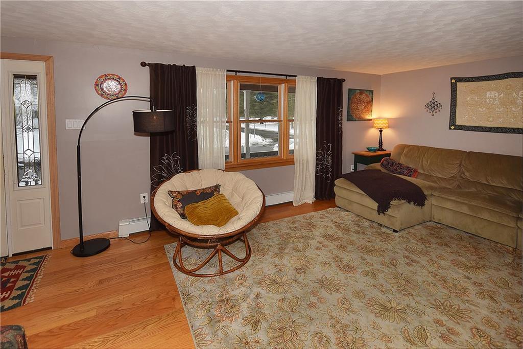 23 Bess Road Enfield, CT 06082 - Photo 1 of 1 a living room with a couch and dresser with mirror