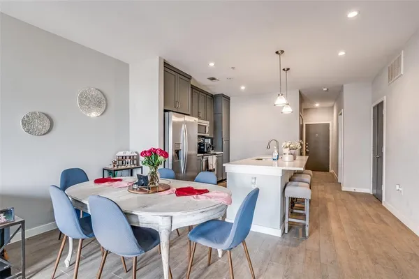 a view of a dining room with furniture and wooden floor