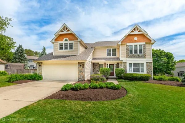 a front view of house with yard and green space