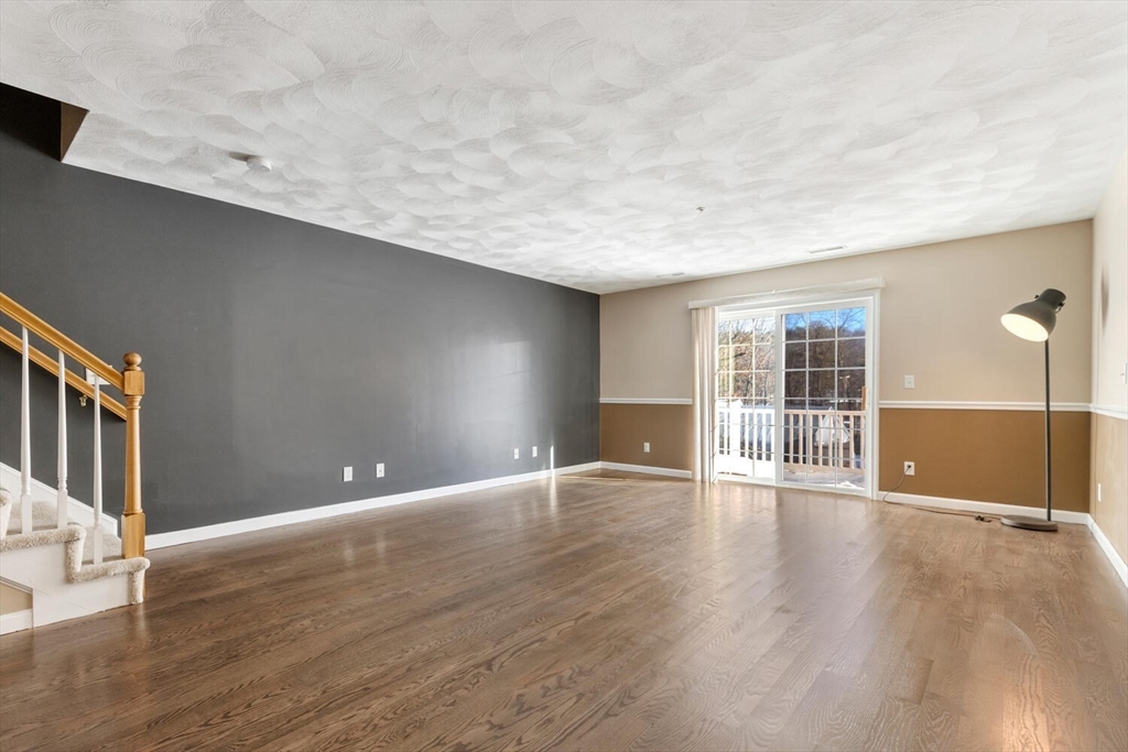 18 Dale Street, Unit 9D Andover, MA 01810 - Photo 15 of 33 a view of an empty room with wooden floor and a window