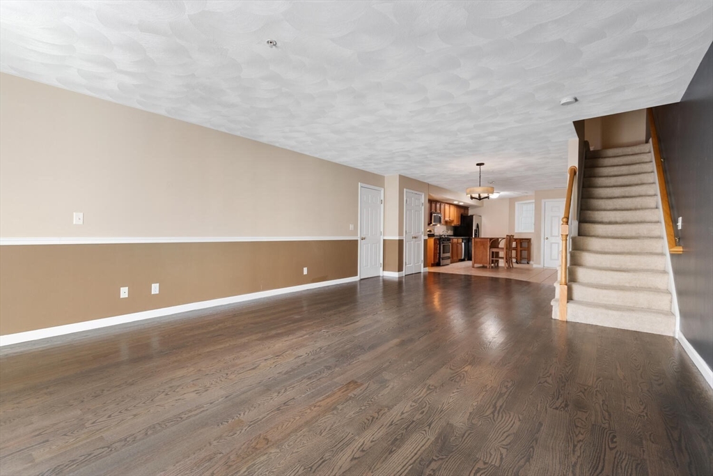 18 Dale Street, Unit 9D Andover, MA 01810 - Photo 16 of 33 a view of a room with stairs and wooden floor