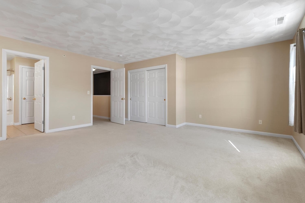 18 Dale Street, Unit 9D Andover, MA 01810 - Photo 25 of 33 a view of an empty room with closet and a window