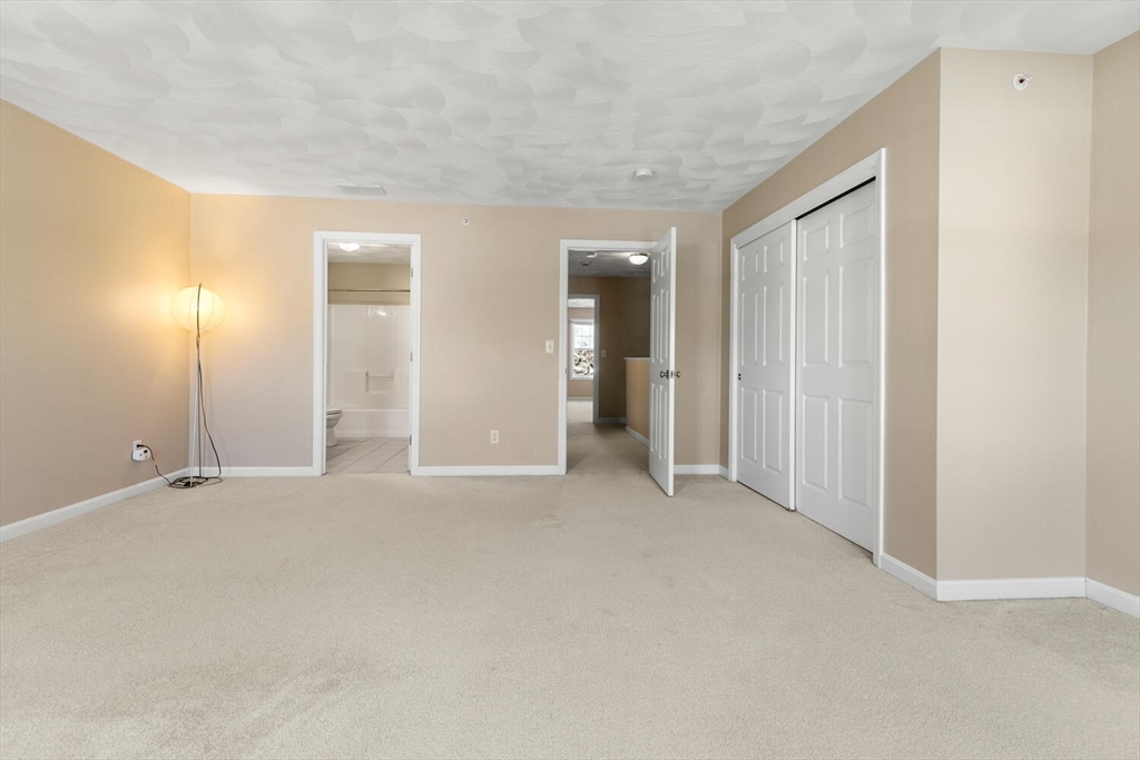 18 Dale Street, Unit 9D Andover, MA 01810 - Photo 26 of 33 an empty room with window in back and closet area