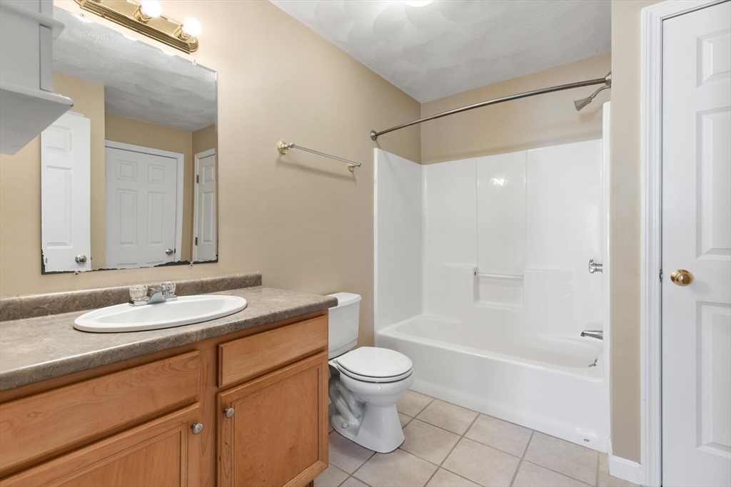 18 Dale Street, Unit 9D Andover, MA 01810 - Photo 27 of 33 a bathroom with a granite countertop sink toilet and shower