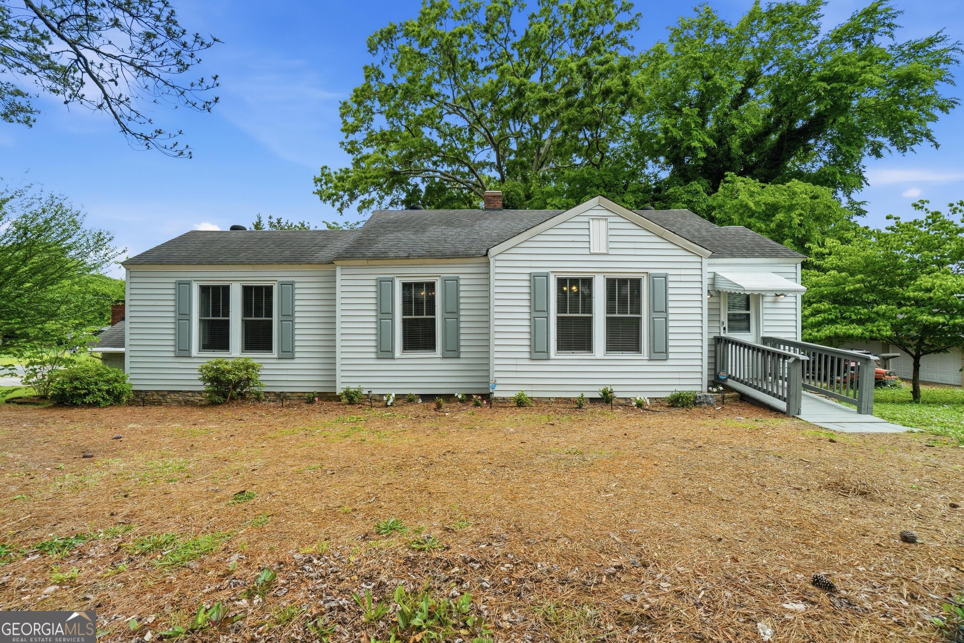 3022 Maple Road Southeast Lindale, GA 30147 - Photo 25 of 29 a front view of a house with a garden